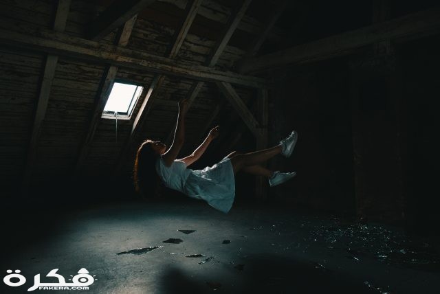 woman in white dress falling on gray concrete floor 3856635